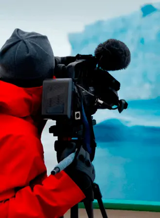 pessoa com um camera filmando uma geleira